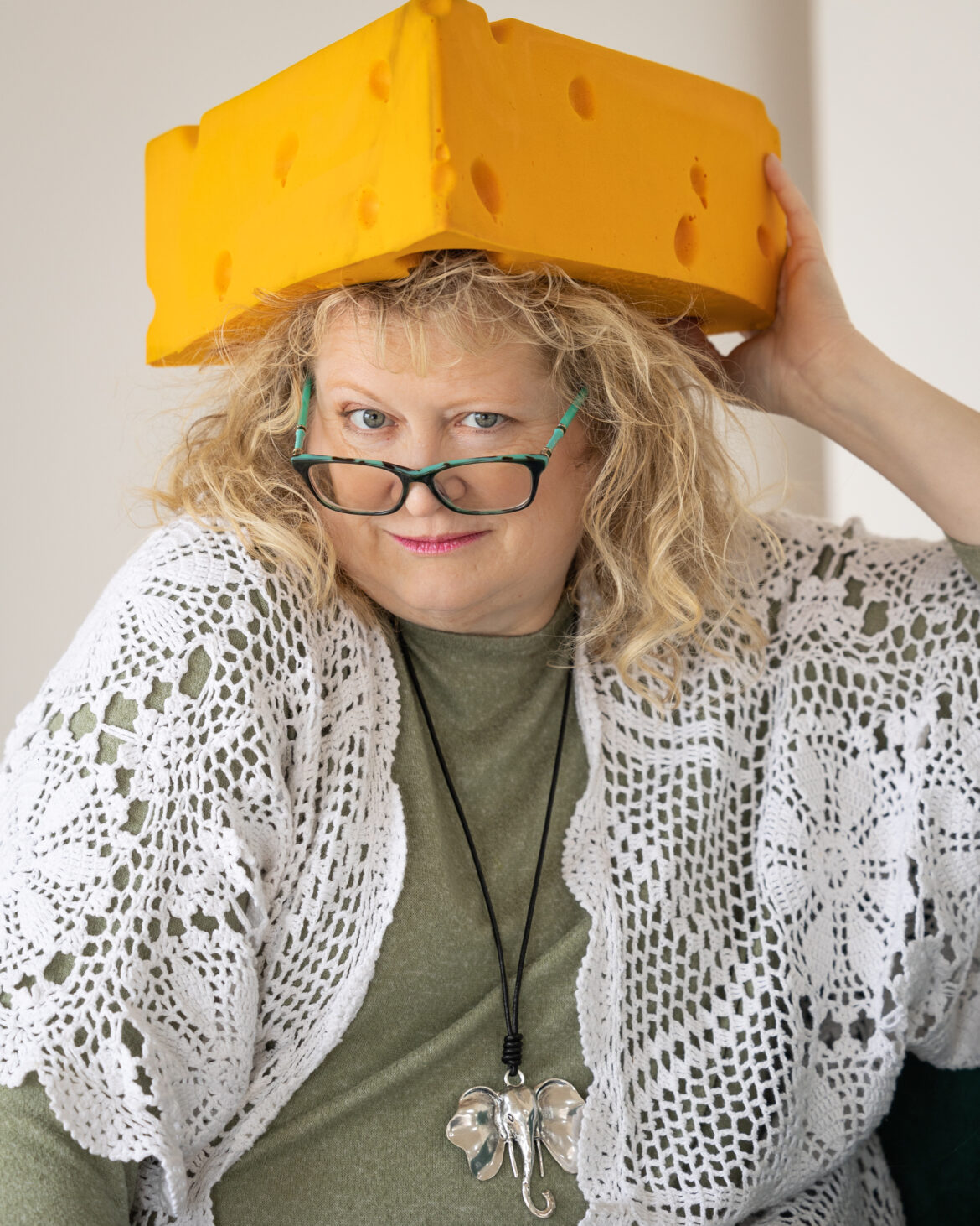 Photo of author Dannelle Gay with a cheesehead hat on their head