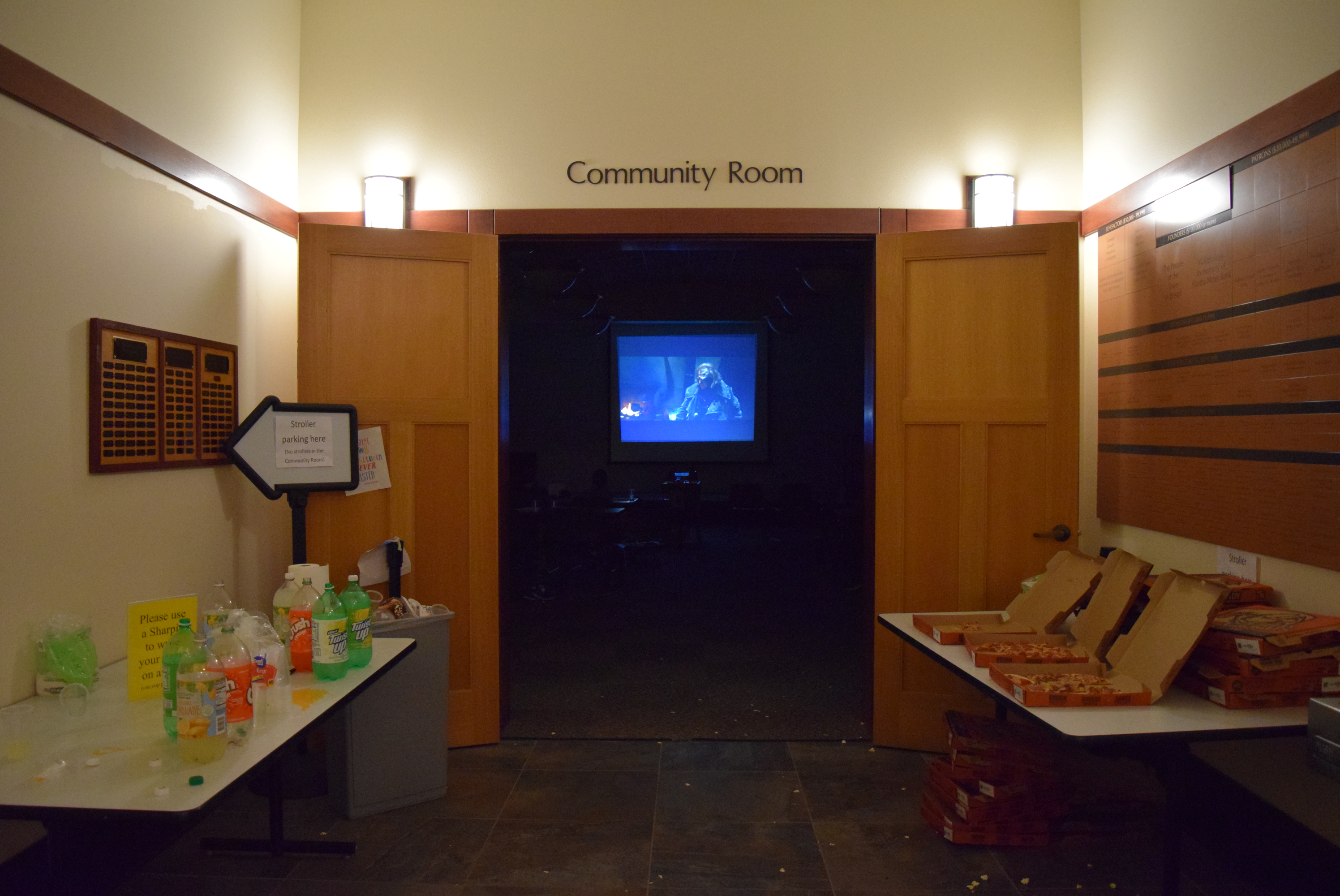 Library Community Room entrance, surrounded by pizza and soda bottles.