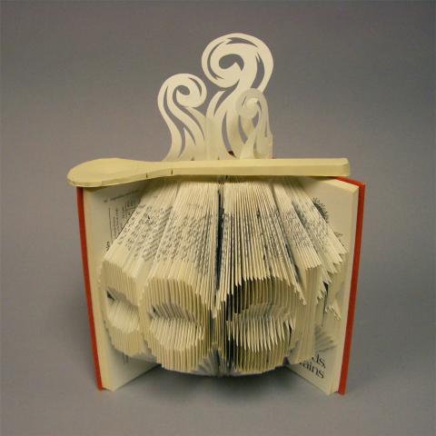 altered book with the word cook folded into it