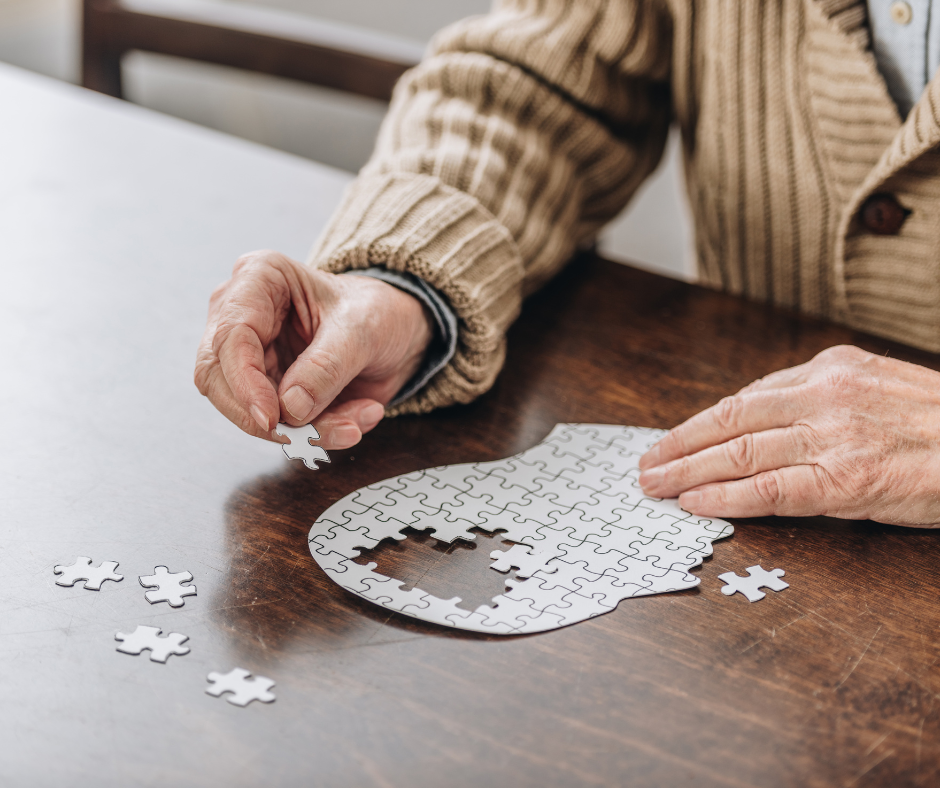 Person working on a puzzle of human brain with pieces missing